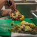 Warrant Officer 1 Daniella Blanco cuts an artichoke