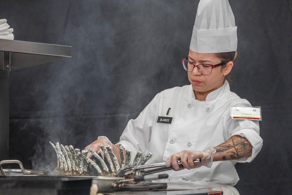 Warrant Officer 1 Daniella Blanco checks a rack of lamb