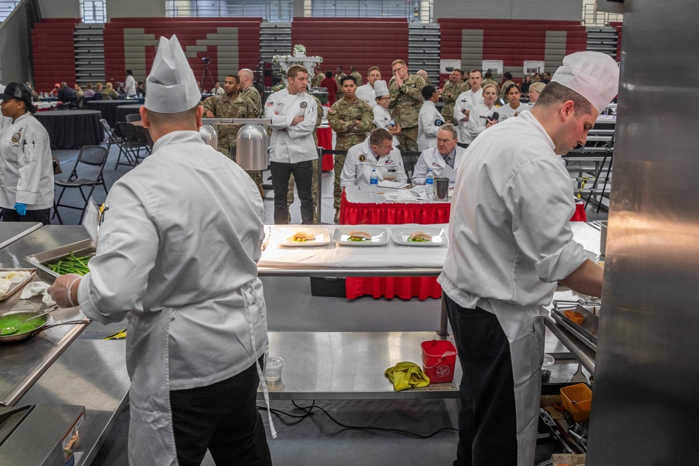 Sgt. Jacob Hernandez and Sgt. Steven Philipps prepare an entree