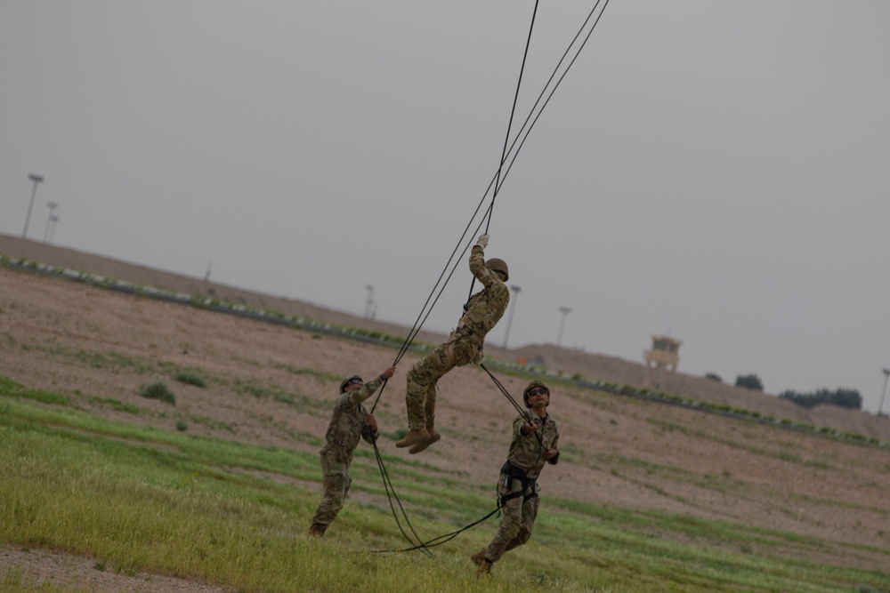 Task Force Spartan Soldiers rappel from Black Hawks during Rappel Master Course