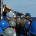 USS Thomas Hudner (DDG 116) hook up fuel lines during a replenishment at sea