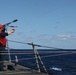 destroyer USS Thomas Hudner (DDG 116), fire a line during a replenishment at sea