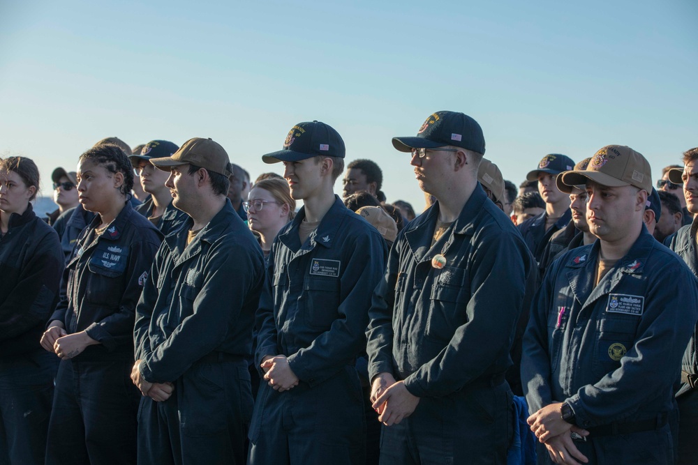 USS Normandy (CG 60) stand in ranks during an all hands call