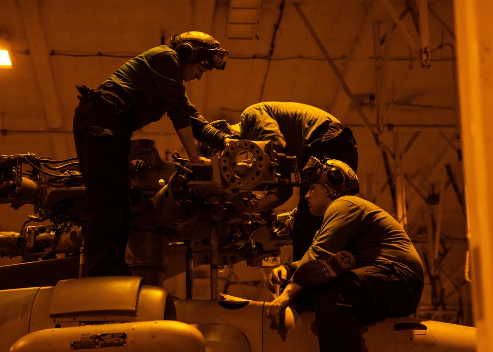 Sailors work on an MH-60S Nighthawk