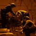 Sailors work on an MH-60S Nighthawk