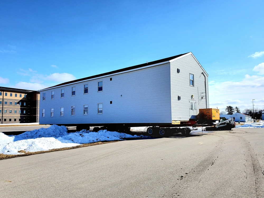 Contractors move second World War II-era barracks building at Fort McCoy