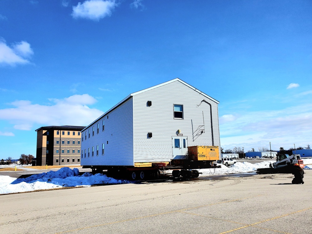 Contractors move second World War II-era barracks building at Fort McCoy