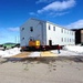 Contractors move second World War II-era barracks building at Fort McCoy