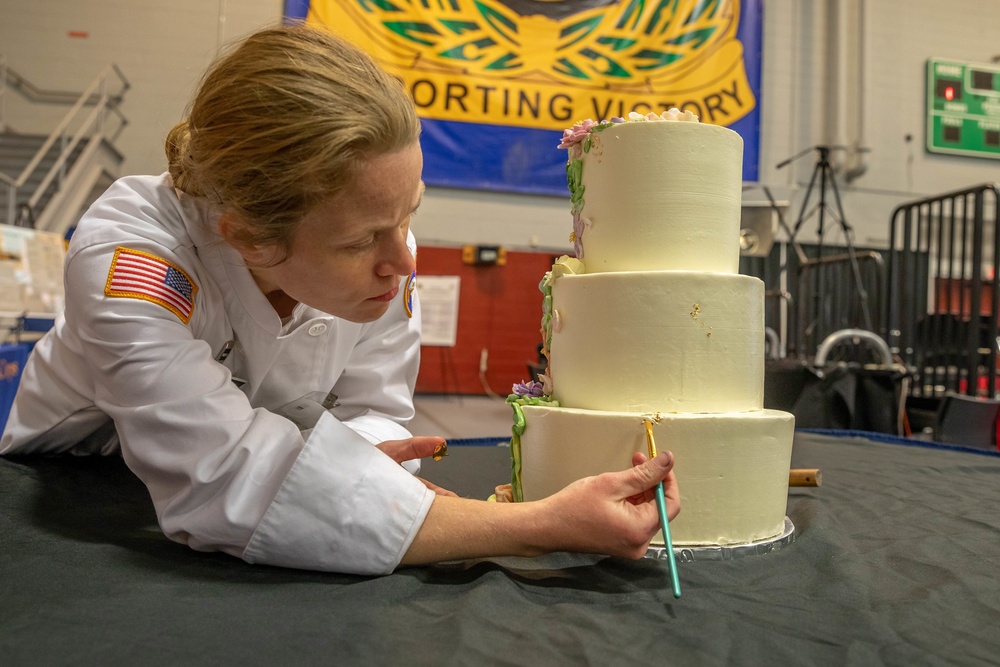 Chief Warrant Officer 2 Christine Stanley puts finishing touches on her cake