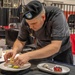 Sgt. Steven Philipps puts finishing touches on his dessert display