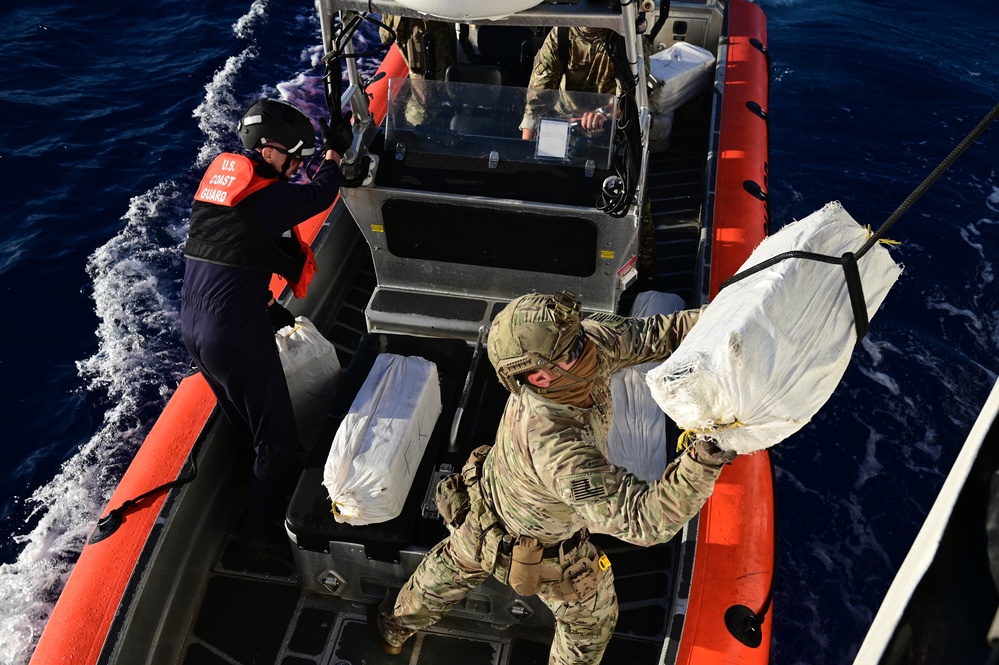 : USCGC Spencer (WMEC 905) embarks suspected drug smugglers and onloads cocaine interdicted by USCGC Heriberto Hernandez (WPC 1114)