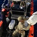 : USCGC Spencer (WMEC 905) embarks suspected drug smugglers and onloads cocaine interdicted by USCGC Heriberto Hernandez (WPC 1114)