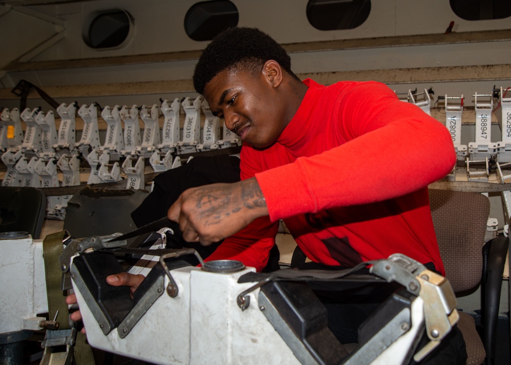 Sailor Performs Maintenance On Weapons Equipment