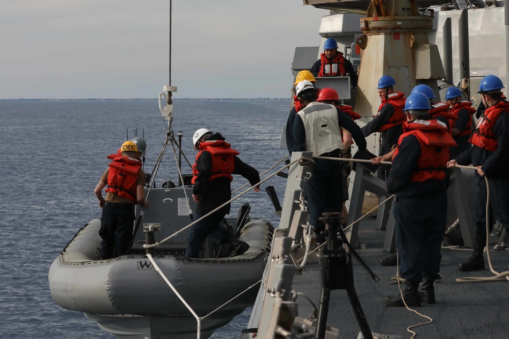 USS Thomas Hudner (DDG 116) board a rigid-hulled inflatable boat