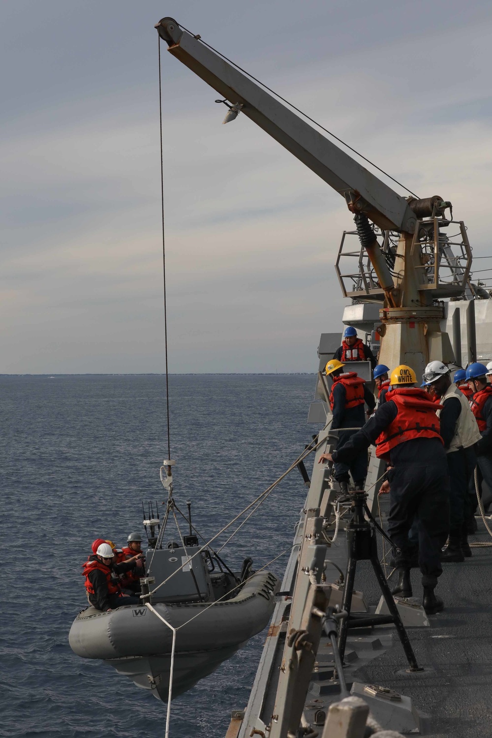 USS Thomas Hudner (DDG 116) lower a rigid-hulled inflatable boat