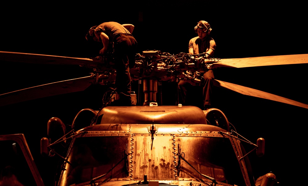 USS Nimitz Sailors Work On Aircraft