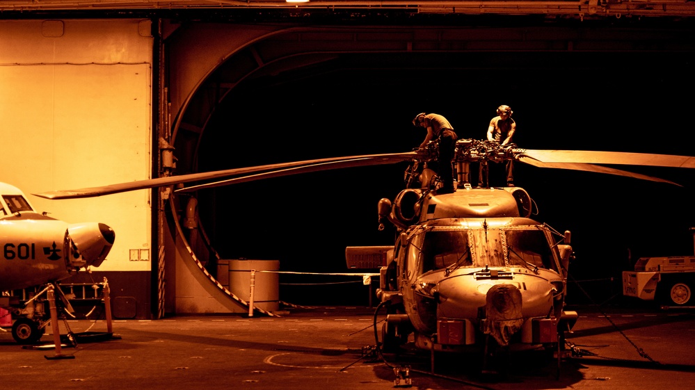 USS Nimitz Sailors Work On Aircraft