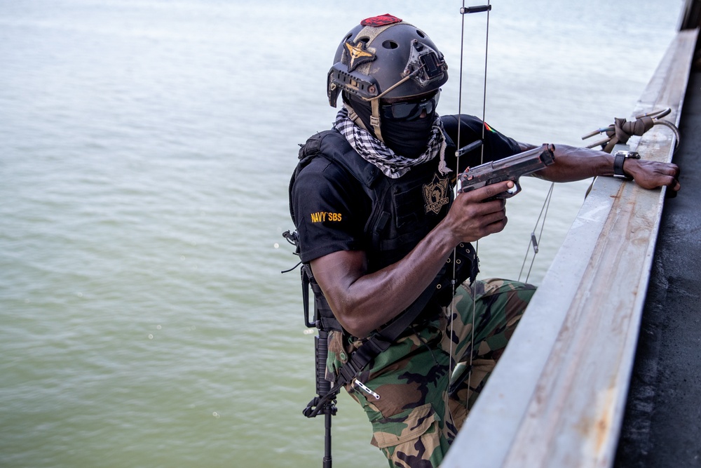 A member of Ghana Armed Forces Holds His Position While Other Team members Climb up a Ladder Flintlock 2023