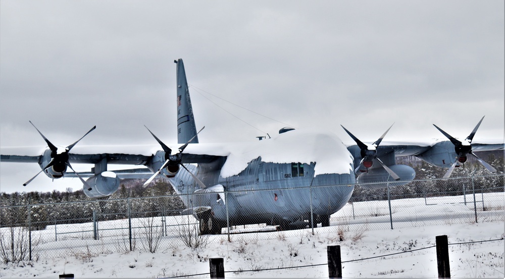 C-130 Hercules training aircraft covered in snow at Fort McCoy