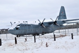 C-130 Hercules training aircraft covered in snow at Fort McCoy