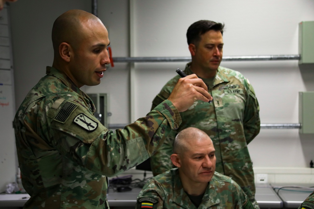 U.S. Army Warrant Officer briefs Lithuanian and U.S. Forces on Geographical Engagement during JMSC-hosted Allied Spirit 23 Command Post Exercise 1
