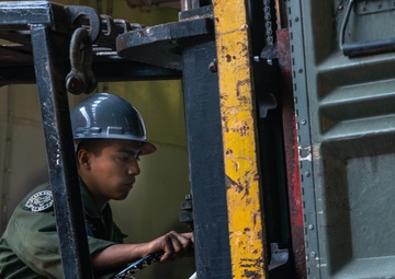3rd Marine Aircraft Wing Marines load aviation support equipment onto the SS Curtiss