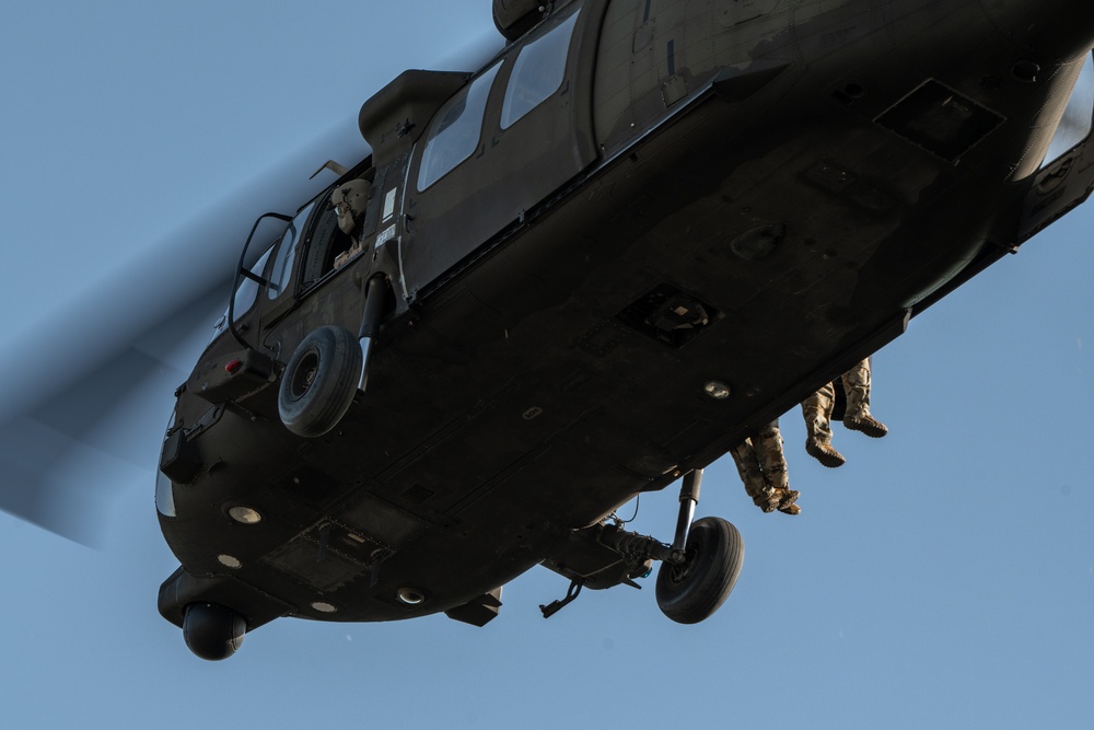 Army reserve conduct rappel training onboard a UH-60 Blackhawk