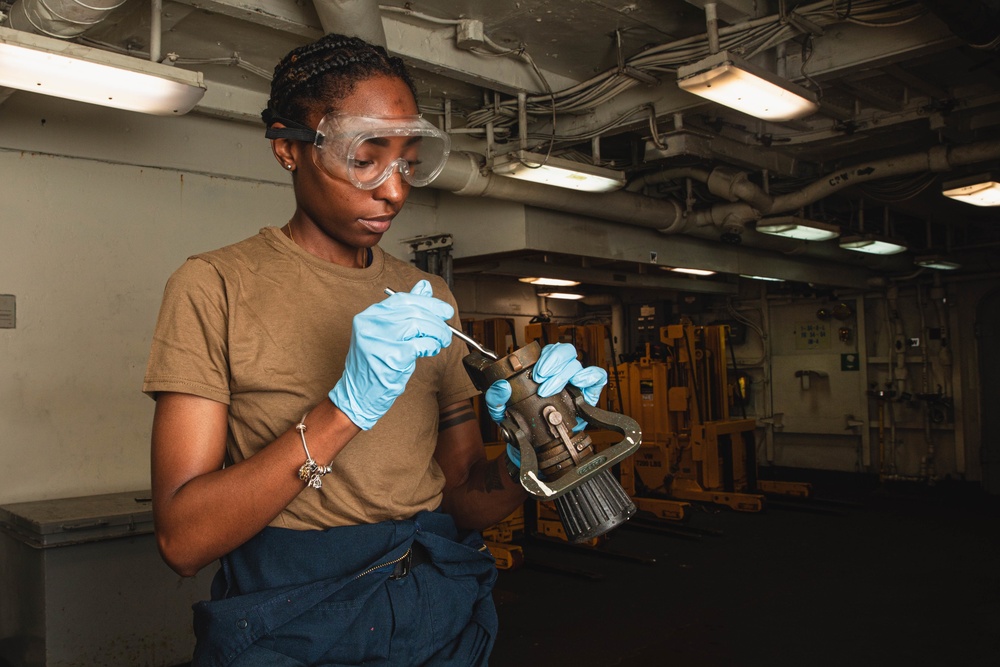 U.S. Sailor Performs Maintenance on Fire Hose