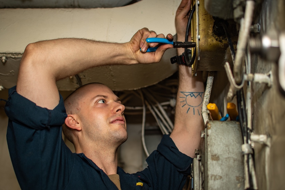 Sailor Performs Maintenance On Connector Box