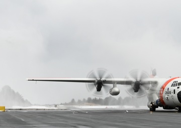 Coast Guard Air Station Kodiak C-130 Hercules airplane receives water salute