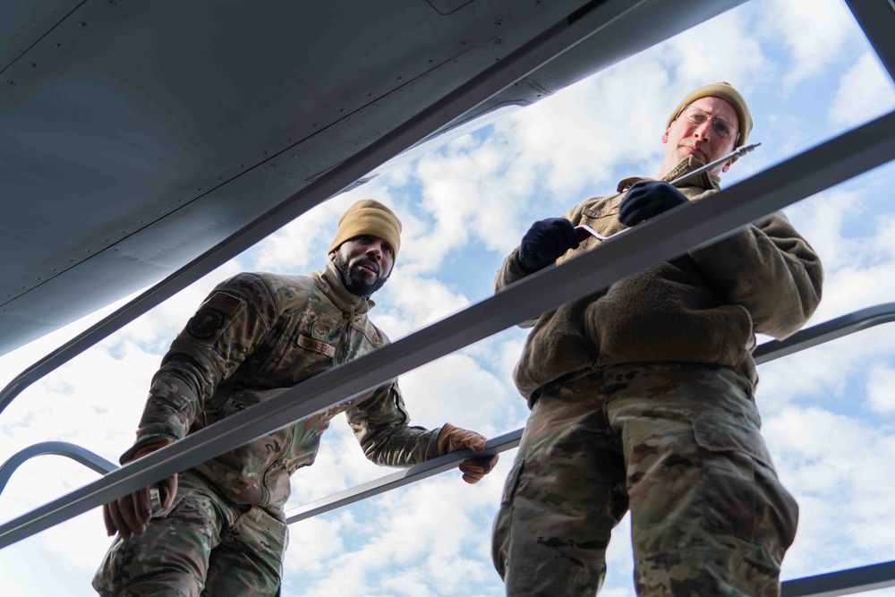 Airmen from the 914th ARW Aircraft Maintenance Squadron working on KC-135's wing lights