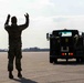 Airman at the 914th guides sewage truck towards aircraft