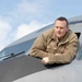 Maintainer leans out front window of KC-135 during pre-flight inspection