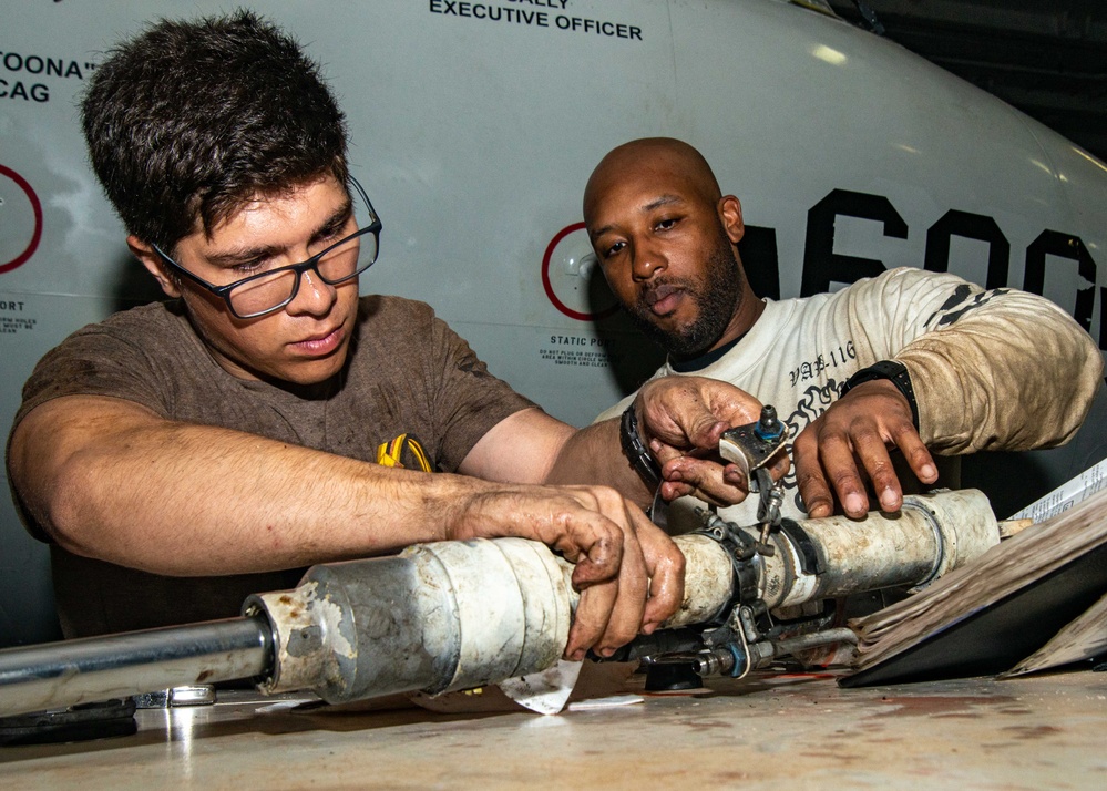 Sailors Disassemble Aircraft Landing Gear Activate