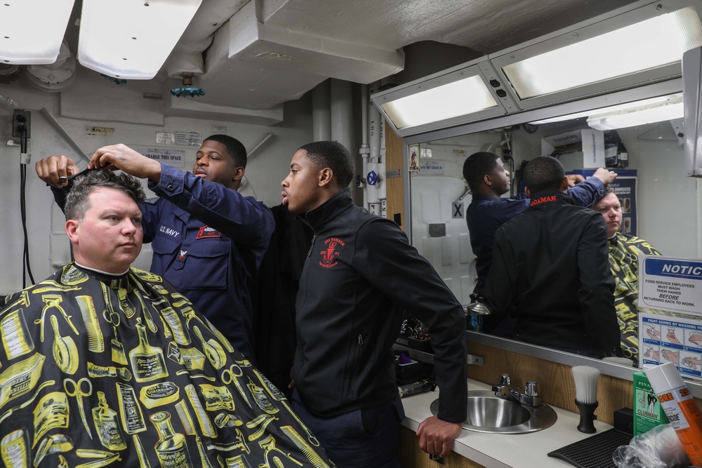 USS Ramage (DDG 61) Sailor receives a haircut in the ships barber shop