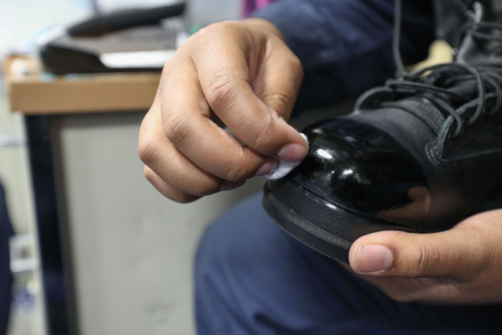 USS Ramage (DDG 61) Sailor shines his boot