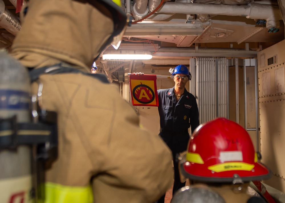 Sailors simulate fighting a fire