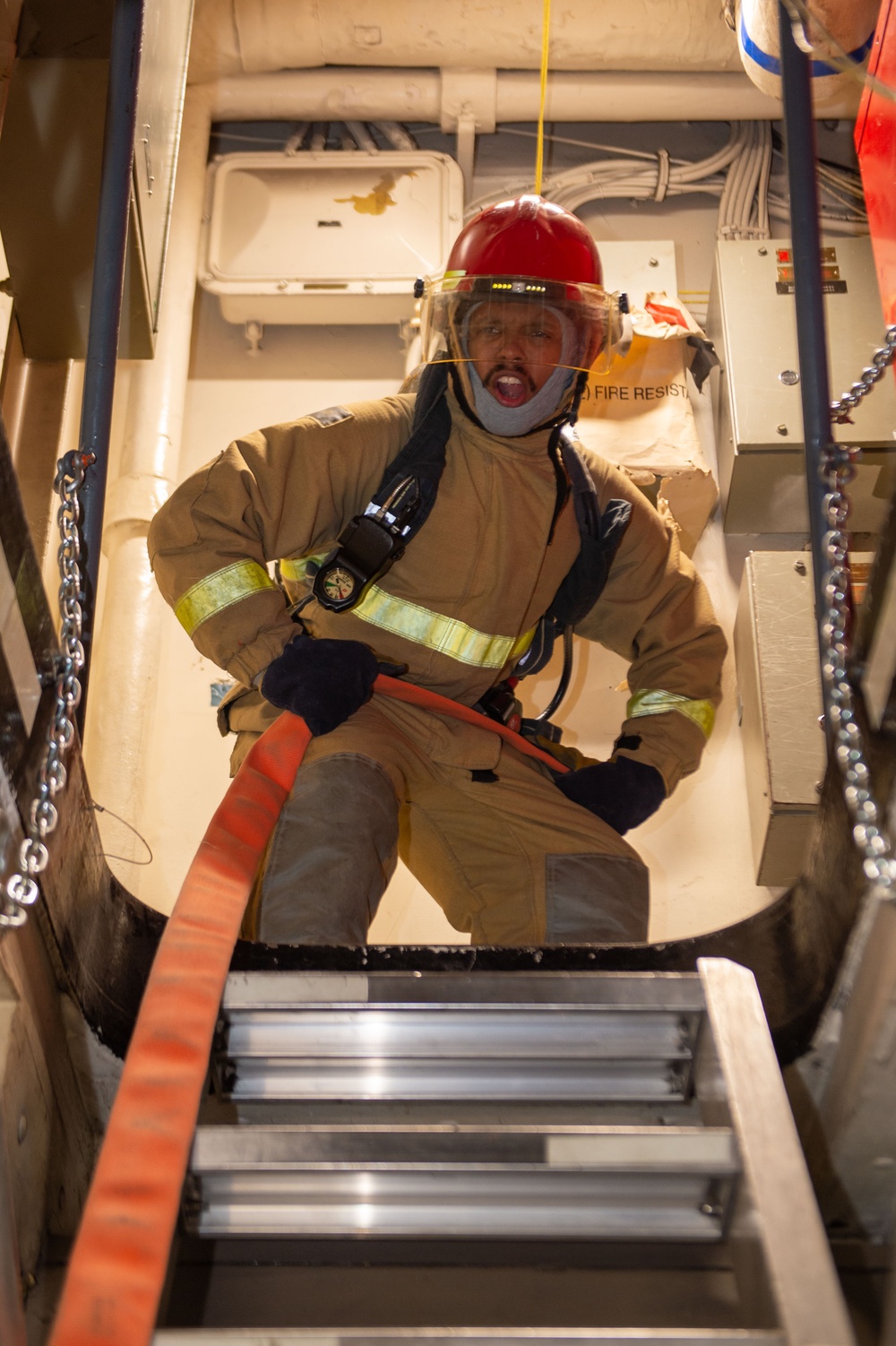 Sailors simulate fighting a fire