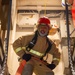 Sailors simulate fighting a fire