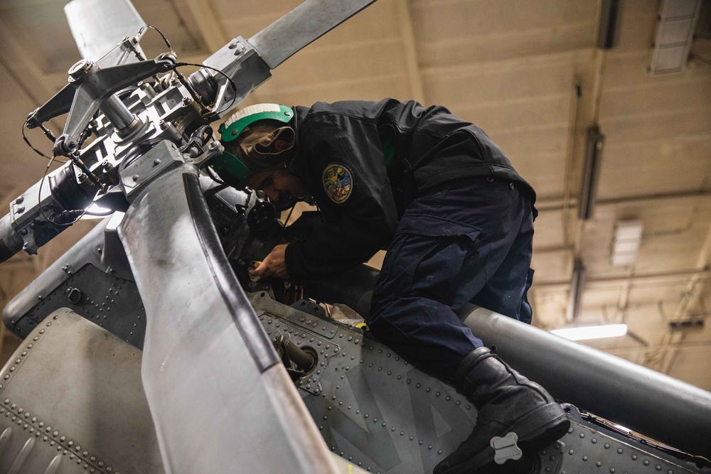 Sailor Performs Maintenance on Sea Hawk Helicopter