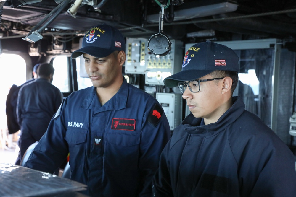 USS Ramage (DDG 61) sailors stand watch at the helm