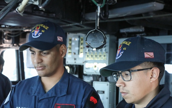 USS Ramage (DDG 61) sailors stand watch at the helm