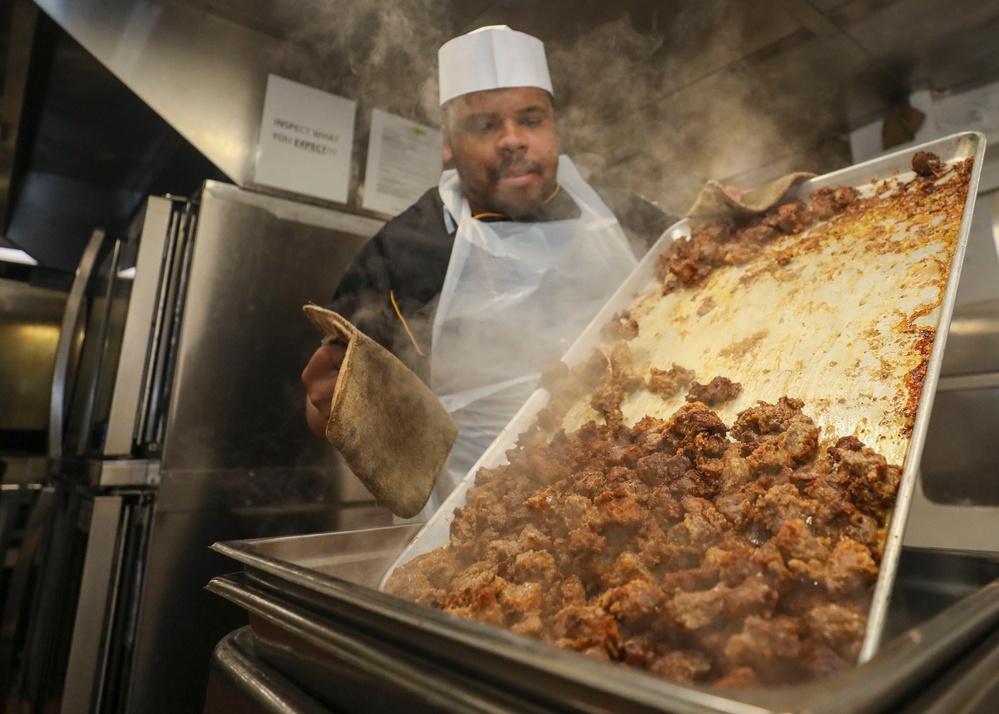 Culinary Specialist Pours Diced Beef
