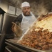 Culinary Specialist Pours Diced Beef