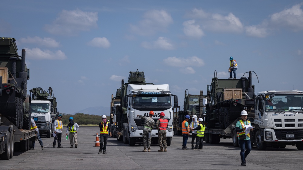 Marines, Soldiers, Airmen, and Filipino Civilians work together to send out equipment in preparation for Balikatan 23