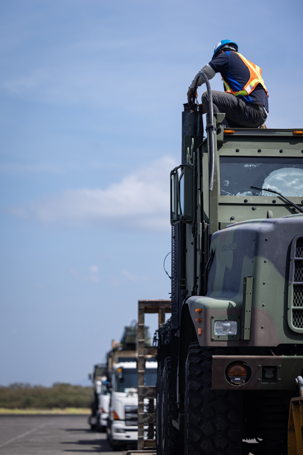 Marines, Soldiers, Airmen, and Filipino Civilians work together to send out equipment in preparation for Balikatan 23