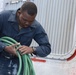 A Sailor aboard USS Ramage (DDG 61) cleans up after hull maintenance