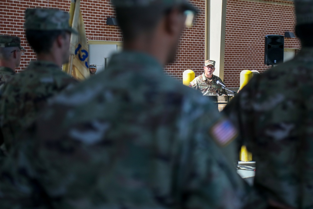 First Sergeants pass 135th Quartermaster Company guidon in ceremony