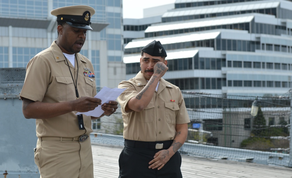 A touching moment during a re-enlistment ceremony aboard Battleship Wisconsin