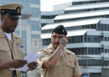 A touching moment during a re-enlistment ceremony aboard Battleship Wisconsin
